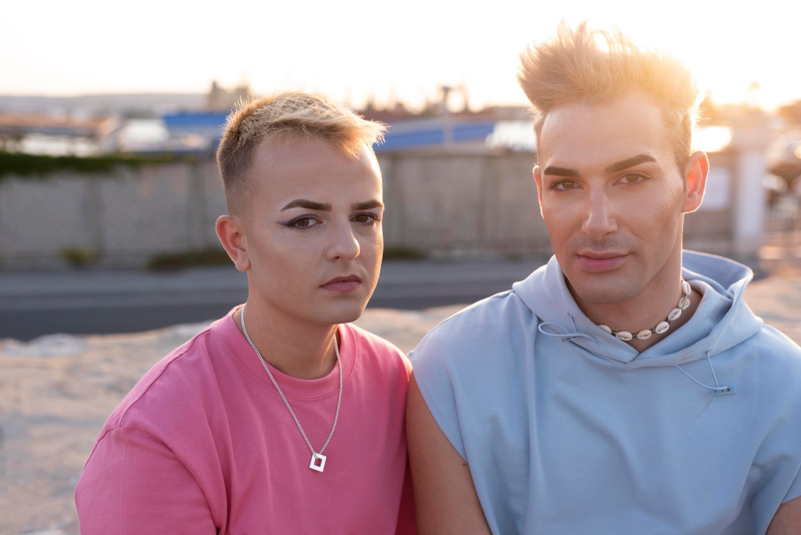 Two gender-diverse adults sitting together outdoors